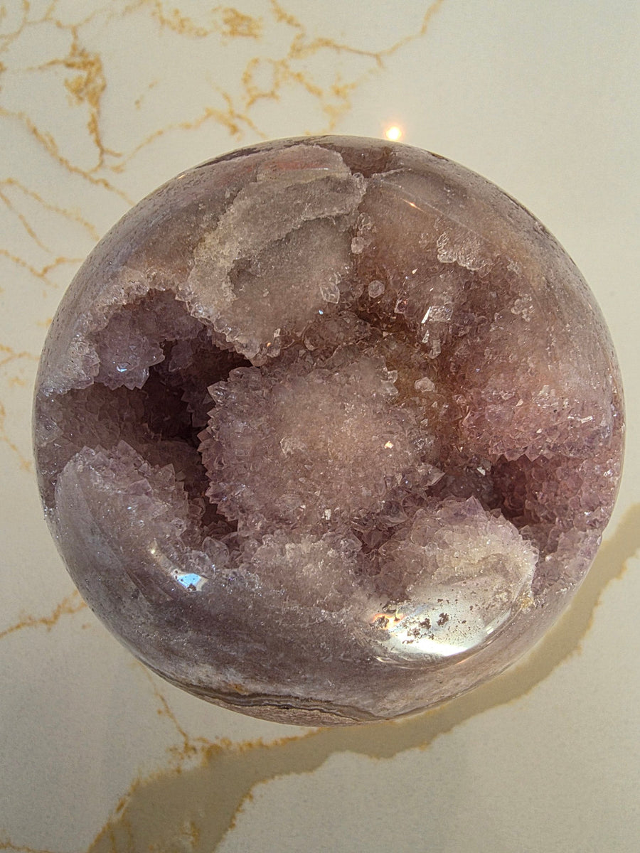 Pink amethyst geode sphere with sparkling druzy cavity