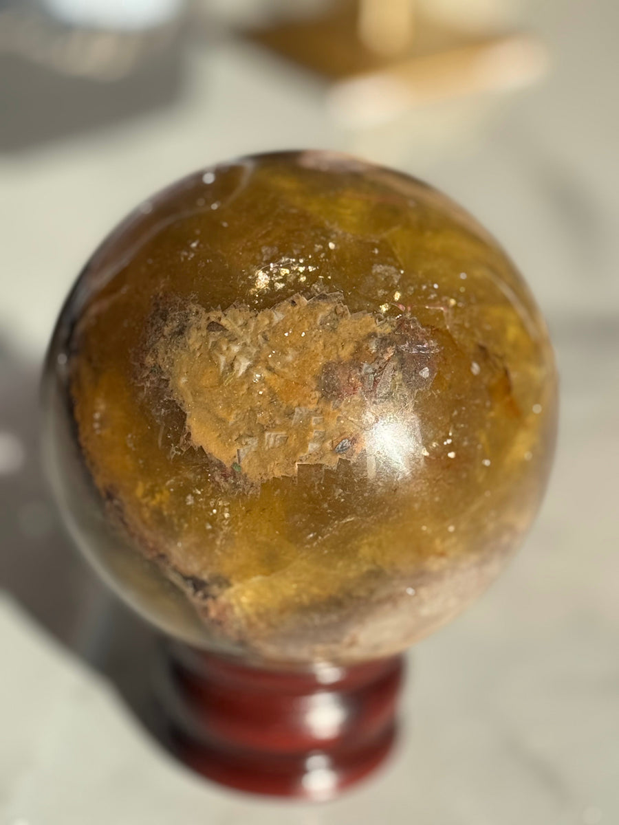 Polished crystal sphere with golden inclusions – crystals £50 to £100