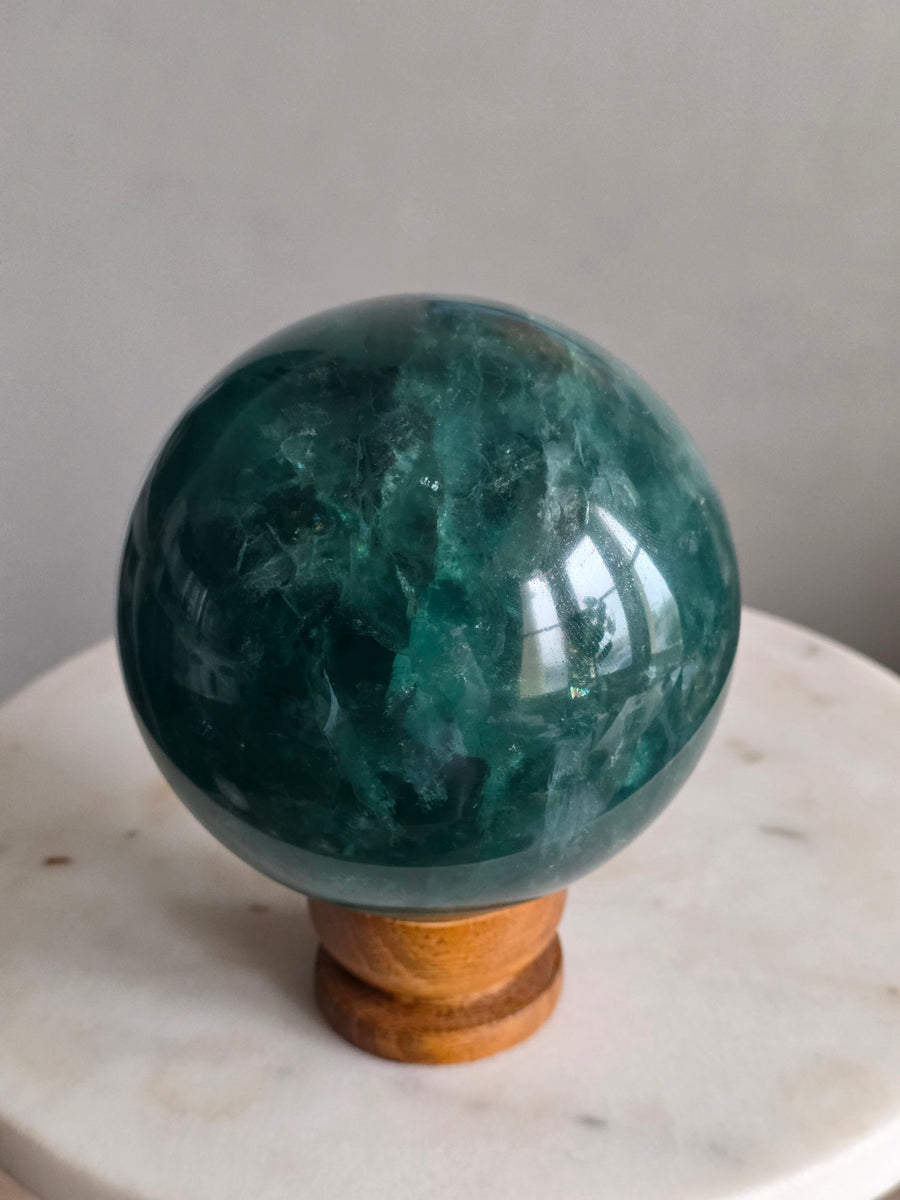 Large green fluorite sphere 10.8cm, 2.1kg, natural crystal ball from Brazil on wooden stand – front view