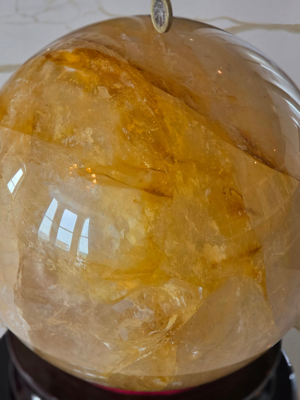 Golden healer quartz sphere with honey-gold inclusions