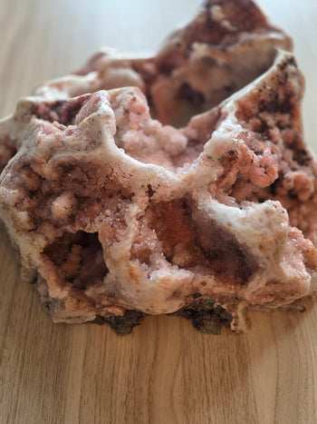 Rose-pink druzy caves and arches on a large natural pink amethyst geode