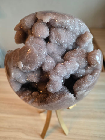 Deep druzy crystal cave in a large pink amethyst sphere from Brazil