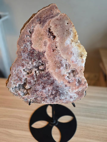 Angled view of pink amethyst slab with crystal pockets and golden calcite edge