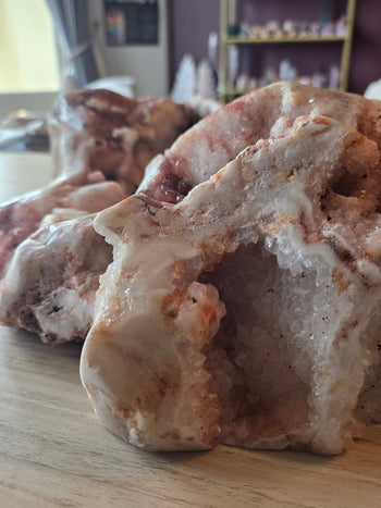 Side view of 13kg pink amethyst freeform geode with sparkling crystal tunnels