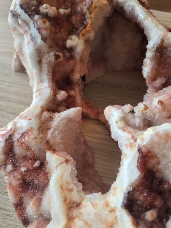Crystal tunnel through a pink amethyst geode lined with pink druzy
