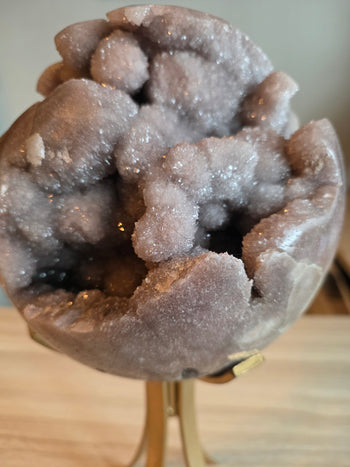 Close-up of cloud-like lilac-pink druzy clusters inside a pink amethyst sphere
