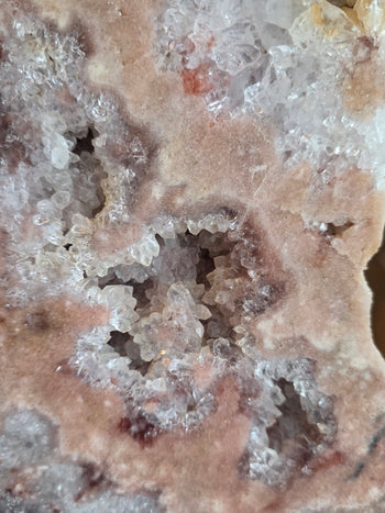 Star-shaped clear quartz clusters with pink centres on pink amethyst