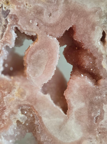 Natural crystal windows through a polished pink amethyst slab
