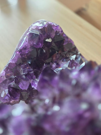 Polished rim of large amethyst geode showing lavender crystal layers