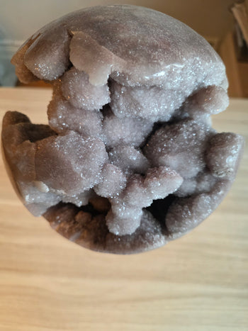 Top view looking into the crystal cave of a large pink amethyst sphere