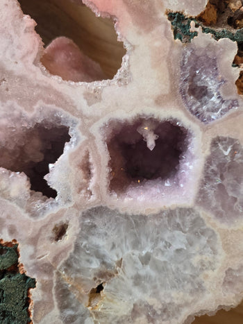 Lavender amethyst and white quartz geode pockets framed in pink chalcedony