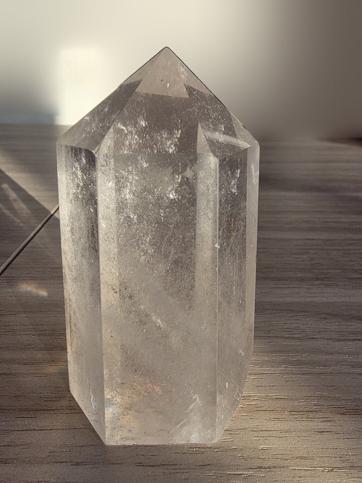 Clear quartz point 9cm, polished six-sided crystal tower, front view