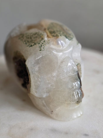 Hand-carved moss agate crystal skull 1.27kg from Brazil – three-quarter front view