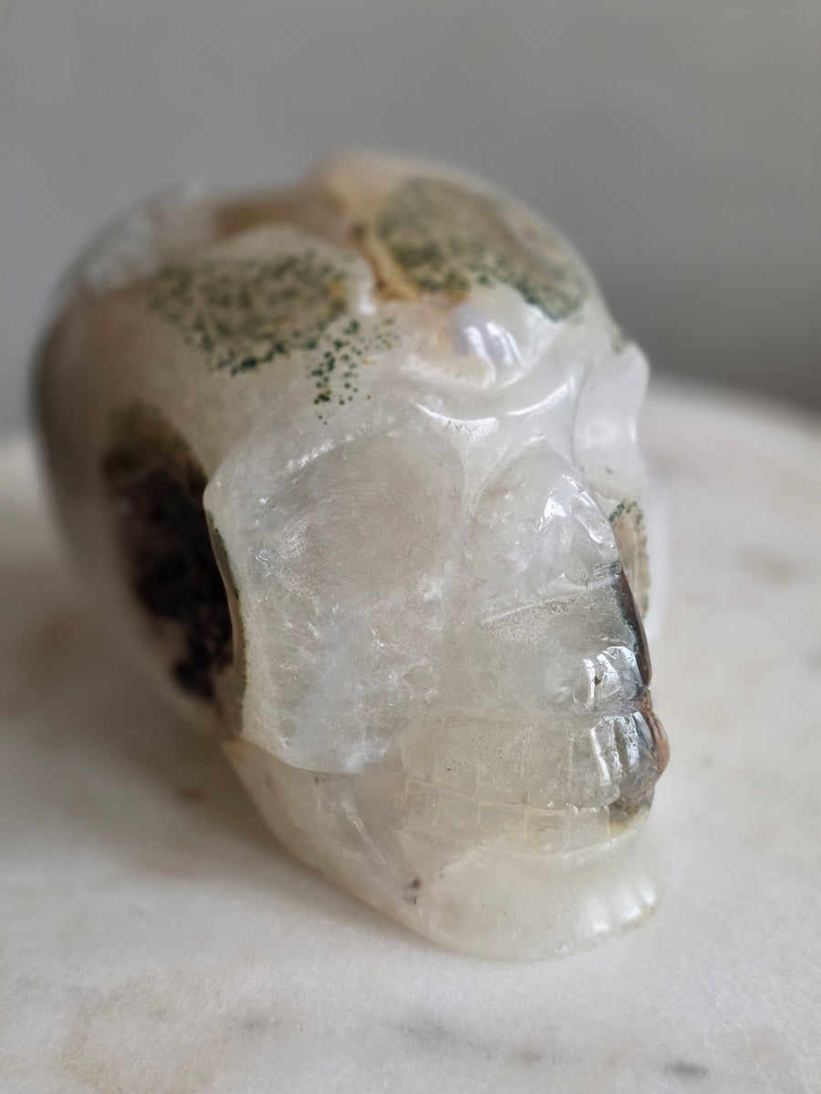 Hand-carved moss agate crystal skull 1.27kg from Brazil – three-quarter front view
