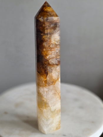 Golden healer quartz point shading from smoky amber to honey gold and white