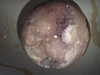 Sparkling blush-pink and lilac druzy crystals on a pink amethyst sphere