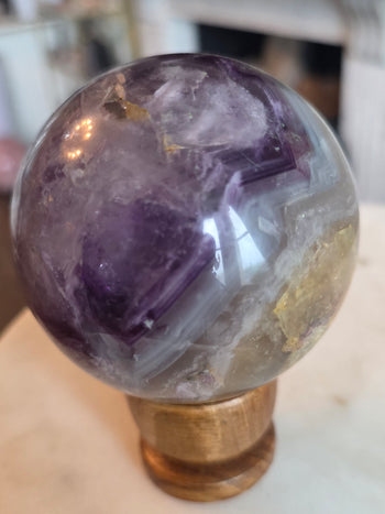 Purple and yellow fluorite sphere 812g, 8cm, from Mexico with stepped purple cubic zoning, white phantoms and golden yellow