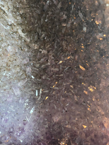 Smoky quartz and pale lavender amethyst crystals inside a tricolour cathedral geode
