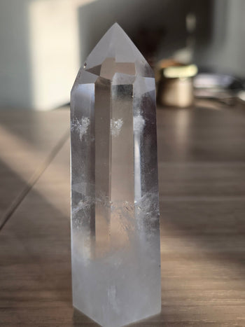Side view of slim clear quartz tower showing misty base