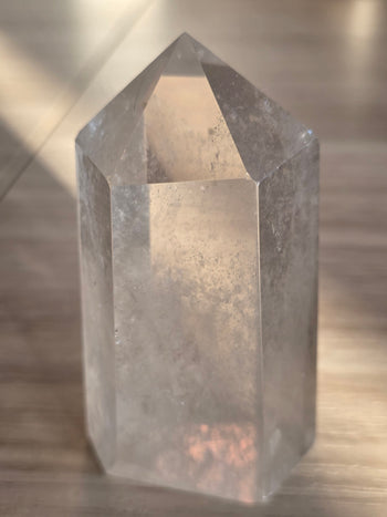 Misty veils running through a polished clear quartz point