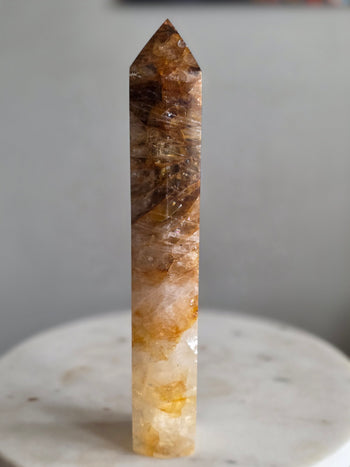 Full length of 22.5cm golden healer crystal tower standing freely