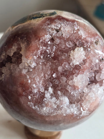 Close-up of clear quartz crystal flower clusters on pink amethyst druzy