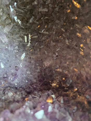 Close-up of sparkling smoky and lavender crystals in a tricolour amethyst cathedral