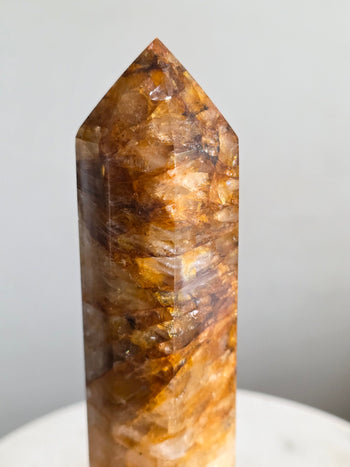 Close-up of golden healer quartz tower tip with honey-gold iron veils