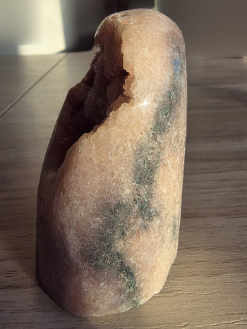 Polished back of pink amethyst geode freeform with natural grey-green markings