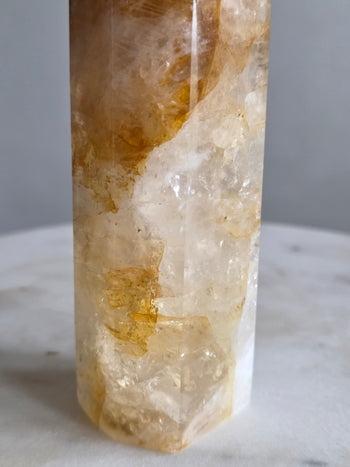 White quartz base of golden healer tower with golden inclusions and rainbow flashes