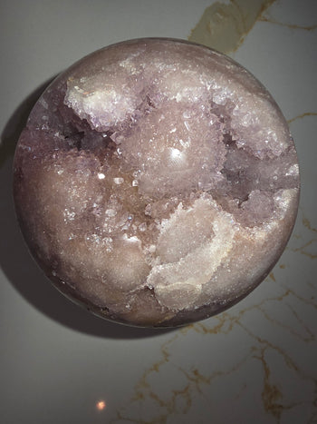 Reverse side of 843g pink amethyst geode sphere showing druzy clusters