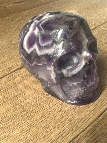 Amethyst crystal skull 805g, deep purple carving, side view
