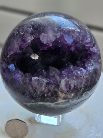 Close-up of deep purple amethyst druzy cavity in 925g geode sphere