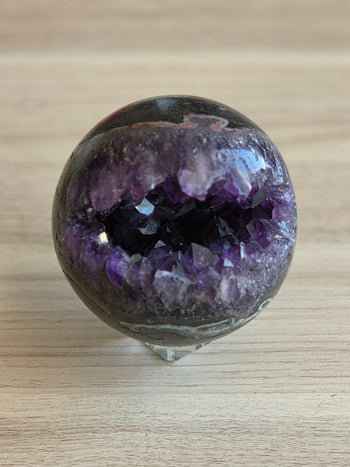 Amethyst geode sphere 925g, polished surface and natural markings