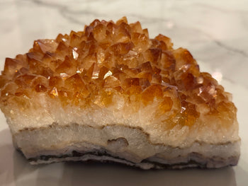 Citrine cluster 2.01kg with golden amber crystal points on a white quartz base, side view