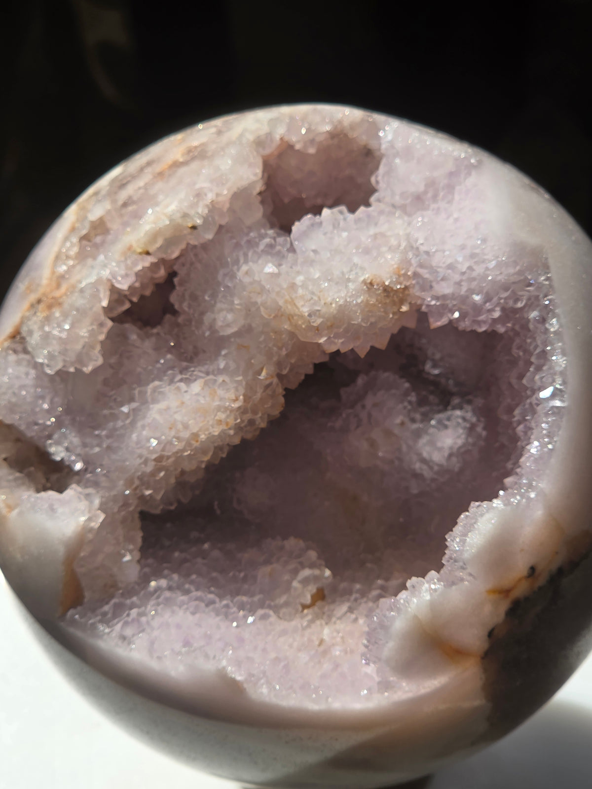 Pink amethyst geode sphere 1.19kg from Brazil with sparkling druzy cavity, front view