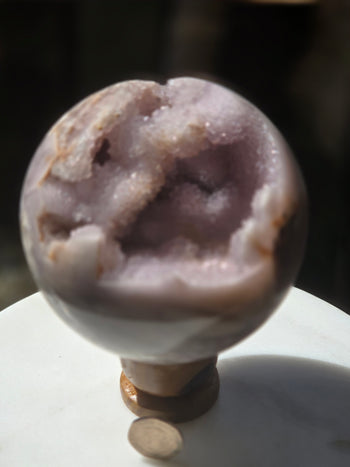 Untreated Brazilian pink amethyst geode sphere 1.19kg, angled view