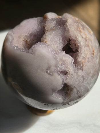 Pink amethyst crystal ball with geode cavity, 1.19kg, detail view