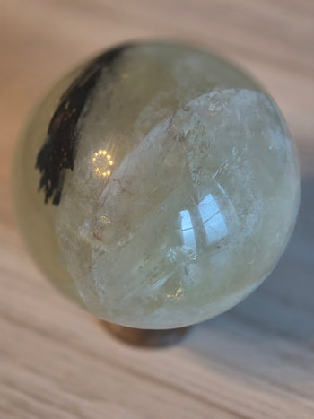 1.5kg citrine sphere with black tourmaline inclusion on wooden stand – view 3